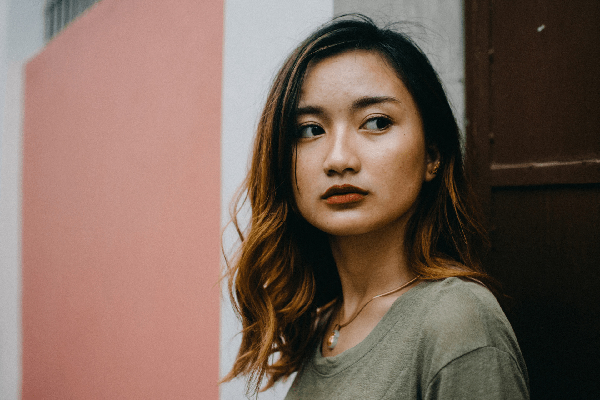 woman outside thinking looking away